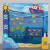 Colorful ocean-themed display with a toy ship above a blue aquarium filled with fish, starfish, and coral.
