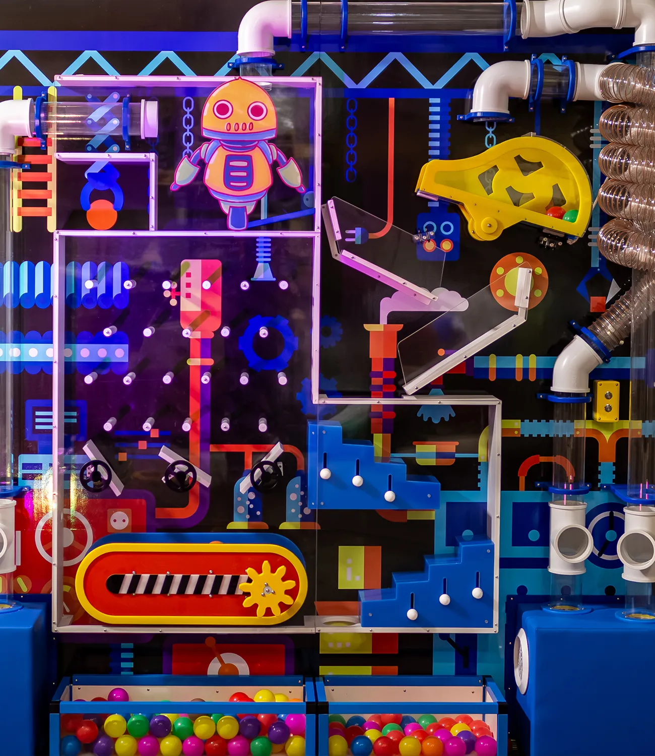 ball-launcher-2 | LiteZilla Colorful arcade machine panel with a cartoon orange robot, gears, tubes, and pulleys for interactive play.