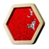 Close-up of a red sequin-covered hexagonal sign framed in light wood.