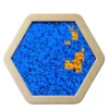 Beige hexagonal frame containing a blue sequin surface with small orange sequin patches forming an abstract pattern