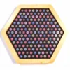 Hexagonal wooden tray with a black interior, densely filled with colorful round ornaments arranged in a grid pattern.