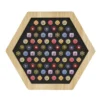 Octagonal wooden tray with a black surface filled with colorful round candies arranged in neat rows.